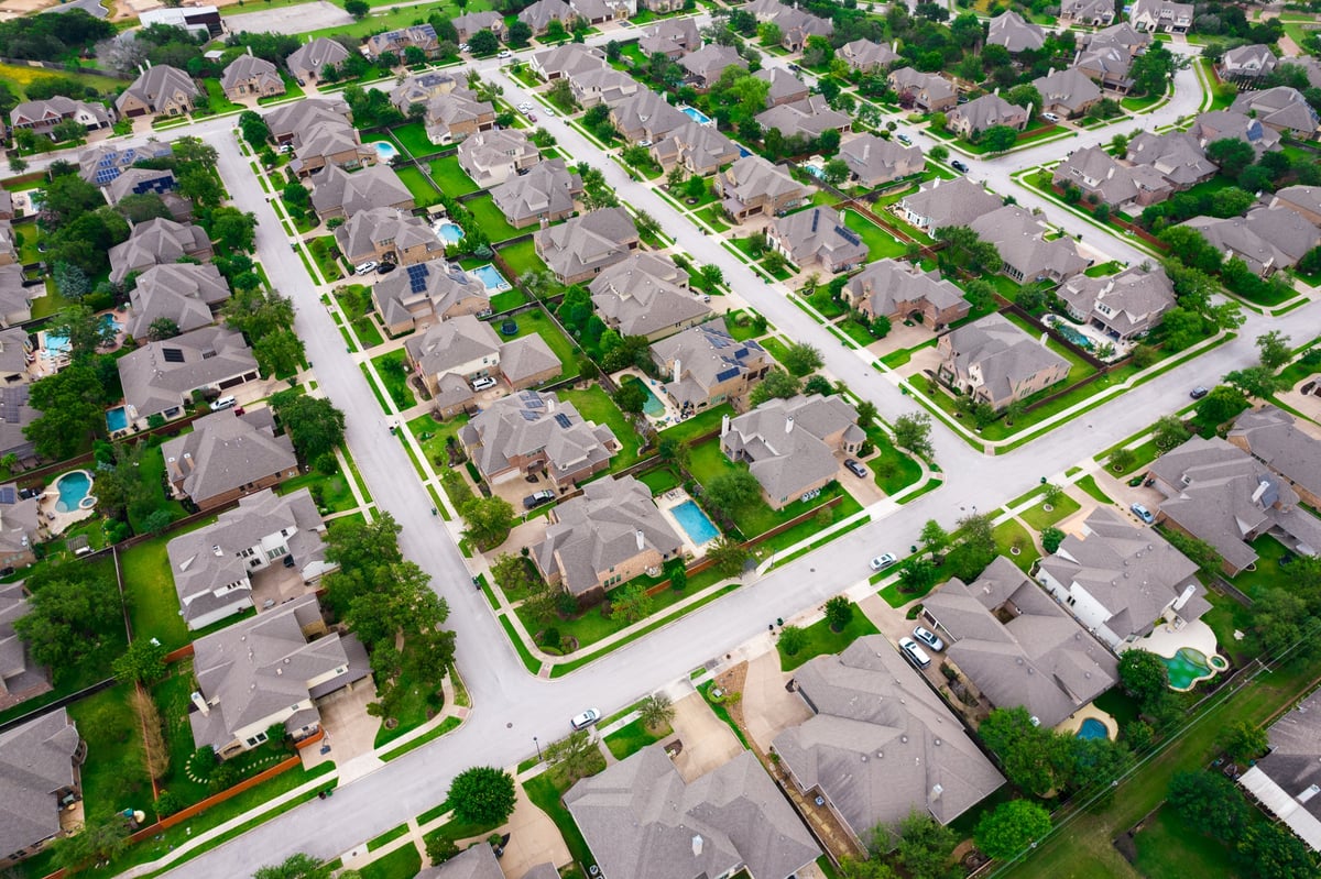 Striaght streets modern streets Row after row of thousands of nice large two story houses Aerial Drone view above Luxury living gated community Suburb